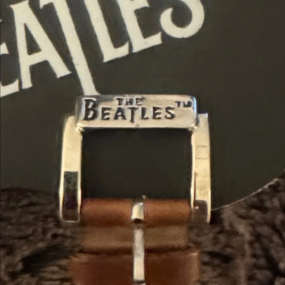 The Beatles Apple Corps Ltd. watch in its original wooden guitar-shaped case.